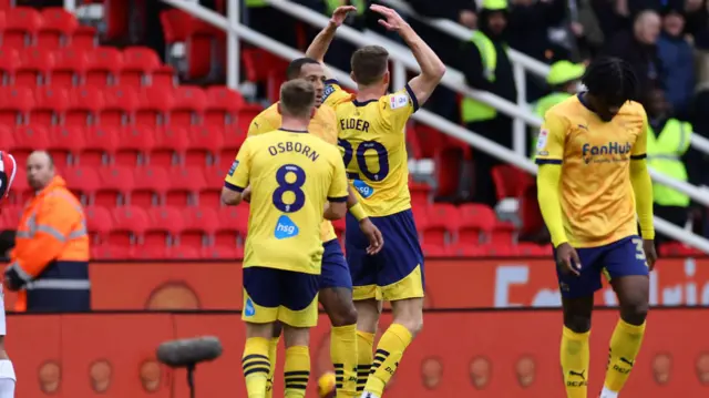 Derby's Callum Elder encourages the away support