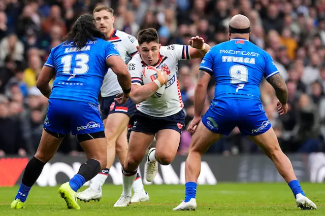 Victor Radley of England is tackled by Luciano Leilua of Samoa and Jazz Tevaga of Samoa