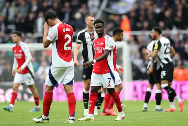 Arsenal players look around at full time after defeat to Newcastle