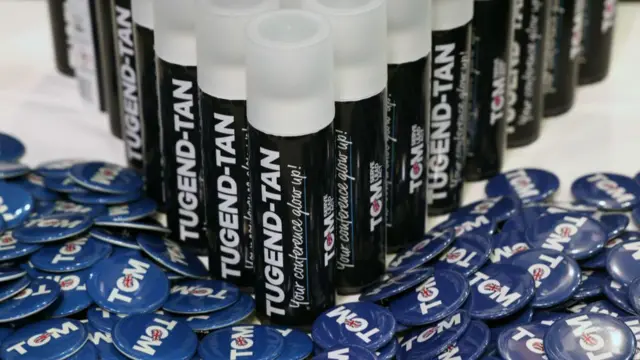 Fake tan and badge merchandise supporting Conservative Party leadership candidate Tom Tugendhat on a stall on the opening day of the UK Conservative Party annual conference in Birmingham,