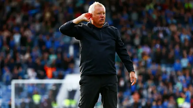 Sheffield United manager Chris Wilder cups his ear to the crowd