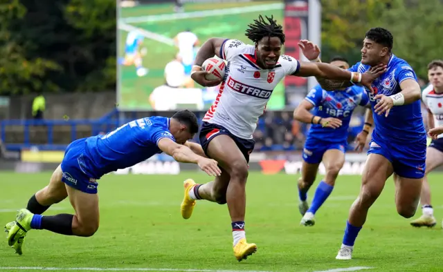 England's Junior Nsemba is tackled by Samoa's Roger Tuivasa-Sheck