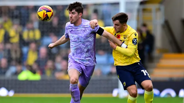 Oxford's Tyler Goodrham battles with Swansea defender Josh Key