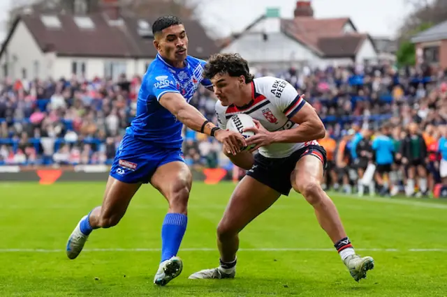 Herbie Farnworth of England is tackled by Deine Mariner of Samoa