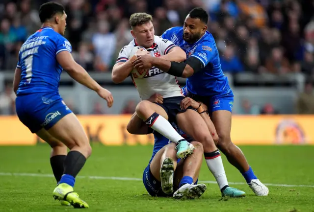 George Williams is tackled by Samoa's Francis Molo and Jeremiah Nanai,