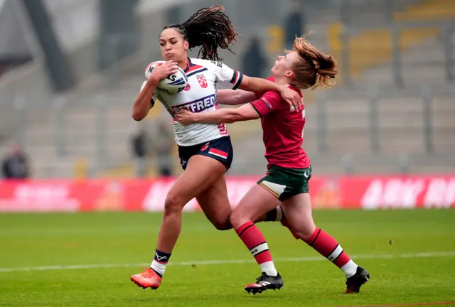 Amelia Brown is tackled by Wales' Dani McGifford