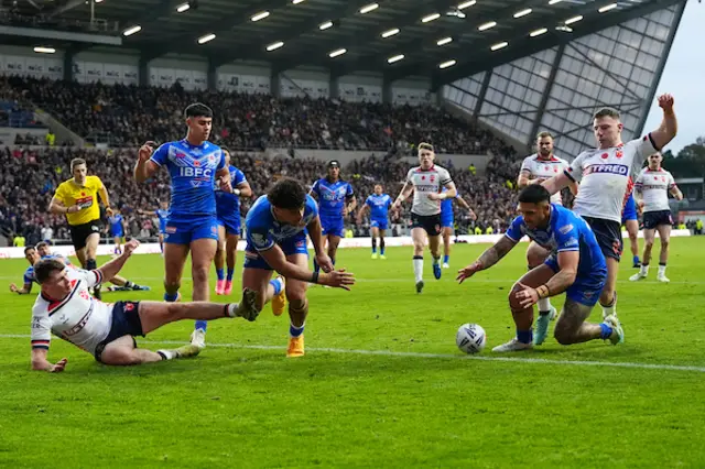 George Williams of England fails to stop Jack Tago of Samoa from scoring a try