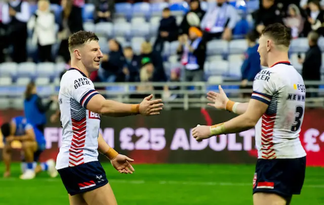 England's George Williams celebrates victory at the end of the match with Harry Newman