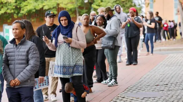 A line of people from diverse backgrounds outside a polling booth in Charlotte, North Carolina