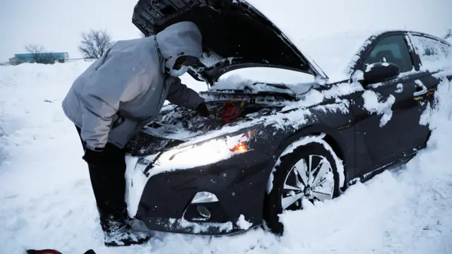 Darnell Saunders of Buffalo checks his car, following a deadly Christmas blizzard, in the western portion of New York, U.S., December 27, 2022