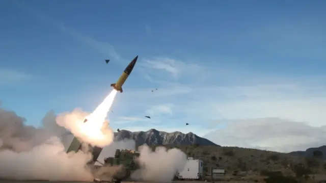 A missile fires from a vehicle into the sky