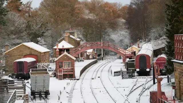 A view of the snow covered rail tracks and platforms at Goathland train station in North Yorkshire