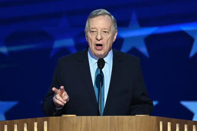 Headshot of Dick Durbin talking and gesturing with one hand