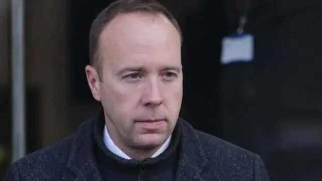 Matt Hancock is seen outdoors wearing a wool coat.