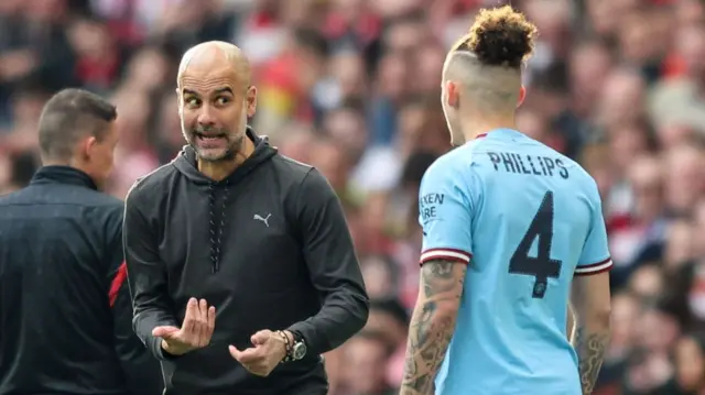 Pep Guardiola talking to Kalvin Phillips