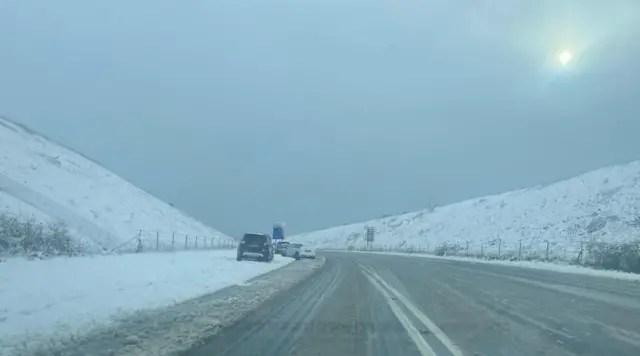 An empty Weymouth Relief Road with snow on the embankments on either side