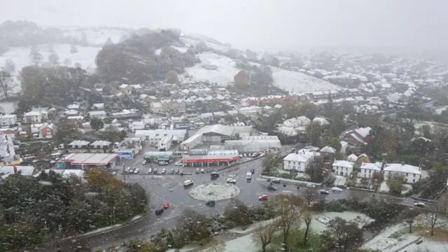 Aerial view of snowy roofs in Bridport. The sky is white and murky.