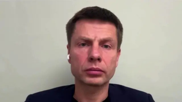 Headshot of Oleksiy Goncharenko against a white wall