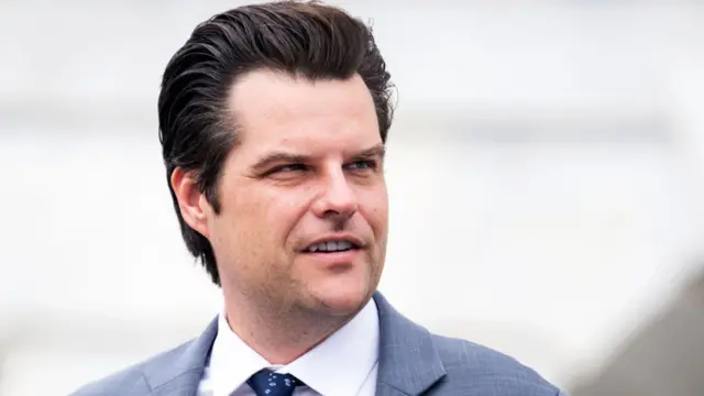 Matt Gaetz wearing a suit and looking to the right of screen