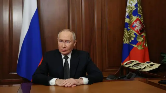 President Putin sits at a desk