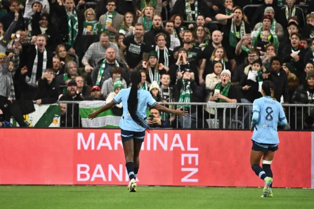 Khadija Shaw (L) celebrates scoring