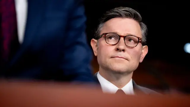 Headshot of Mike Johnson who wears glasses and looks slightly up and to his right