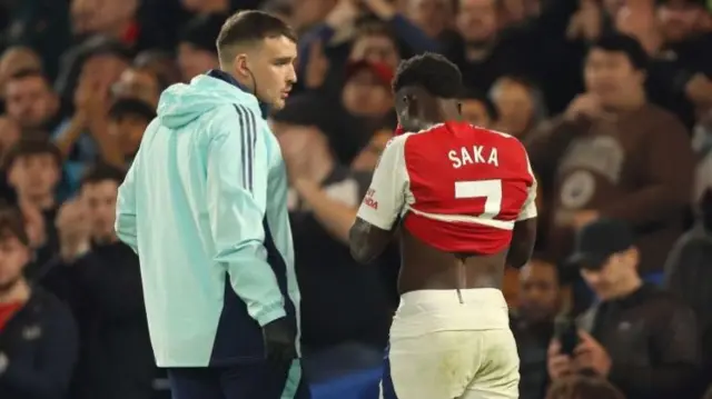 Bukayo Saka walks off inured while playing for Arsenal