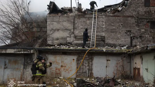 Emergency teams respond at a damaged building in Dnipro.