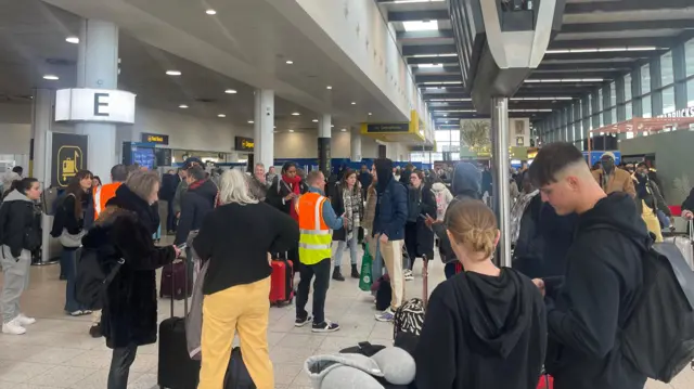 People waiting at Gatwick Airport following a security alert.