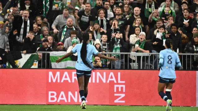 Khadija Shaw celebrates scoring a goal in front of the Hammarby fans