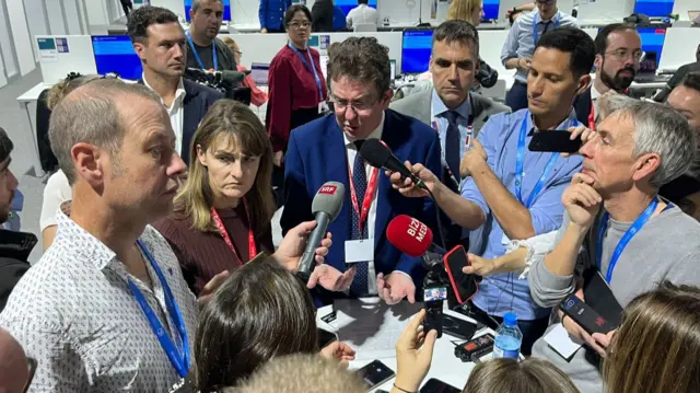 Albert Rösti surrounded by a pack of journalists