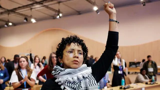 An activist gestures during the "People's Plenary" at the COP29 United Nations climate change conference, in Baku