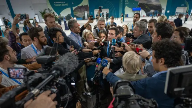 Yalchin Rafiyev, the lead negotiator for COP29 Azerbaijan, surrounded by press