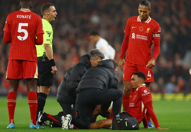 Liverpool's Trent Alexander-Arnold sat on the turf receiving treatment for an injury