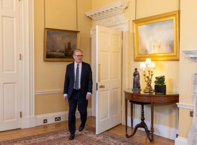 Keir Starmer walks into a room in Downing Street