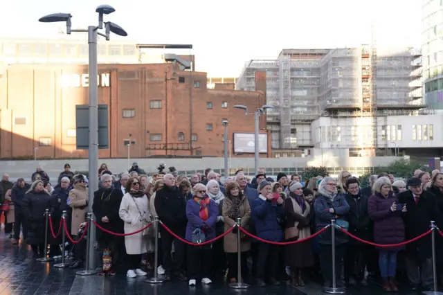 Members of the public attend a memorial service near New Street station