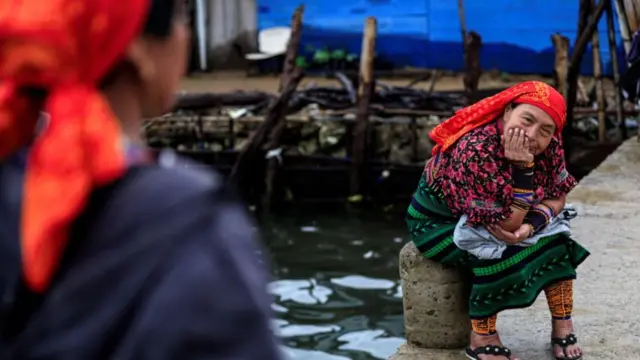 Indigenous Guna women wait on the dock for their transfer from Carti Sugtupu island to the mainland in Guna Yala Comarca, on the Caribbean coast in Panama, on June 03, 2024