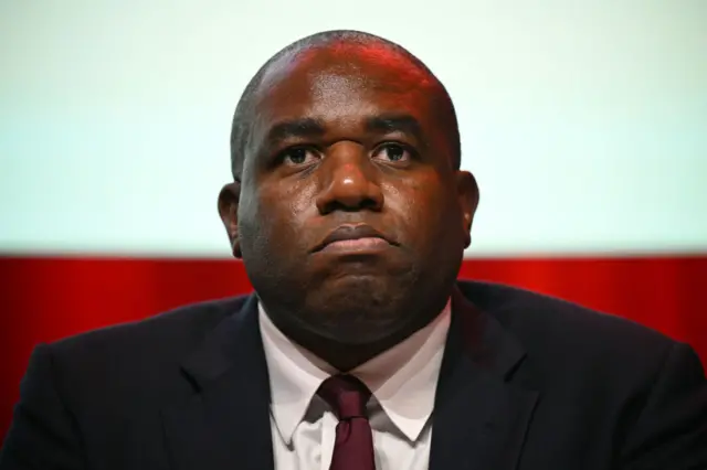 David Lammy, in a suit, looking defiant