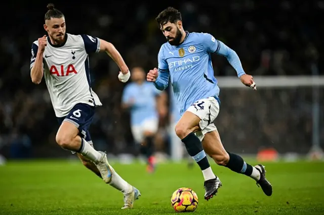 Radu Dragusin (L) fights for the ball Manchester City's Croatian defender Josko Gvardiol