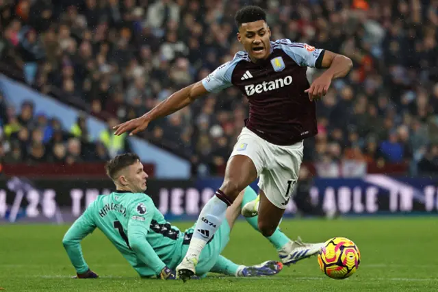 Ollie Watkins takes the ball around Dean Henderson (L) to score their first goal