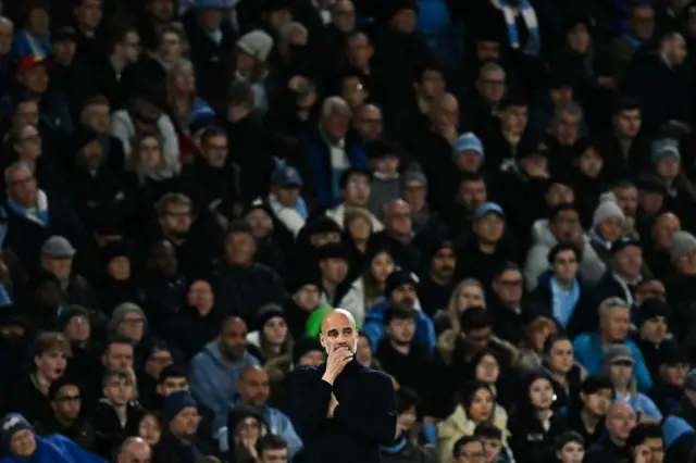 Guardiola holds his chin in his hand