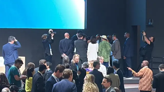 Huddle of people in suits at COP29