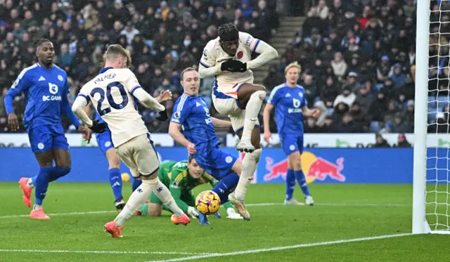 Cole Palmer (2L) has his goal-bound shot blocked by teammate Chelsea's English midfielder #11 Noni Madueke