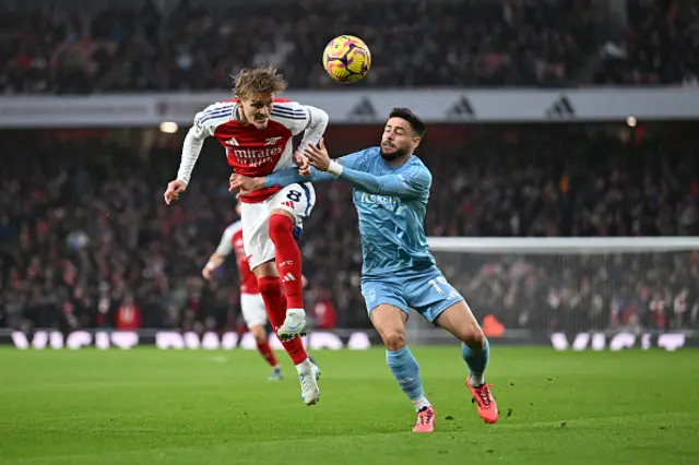 Martin Odegaard of Arsenal is challenged by Alex Moreno