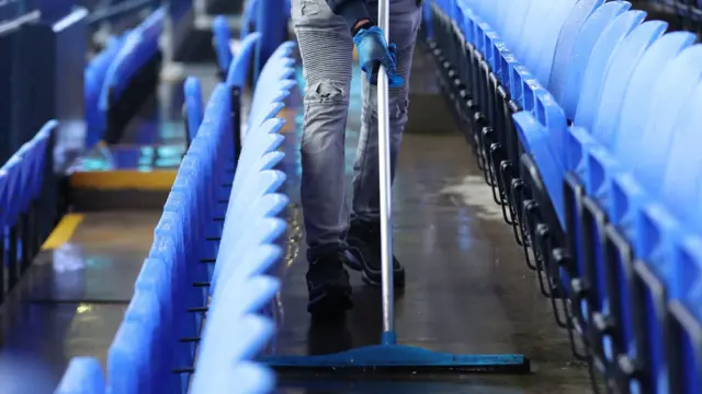 Sweeping up rain at a stadium during Storm Bert