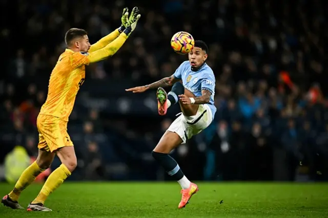 Guglielmo Vicario (L) fights for the ball