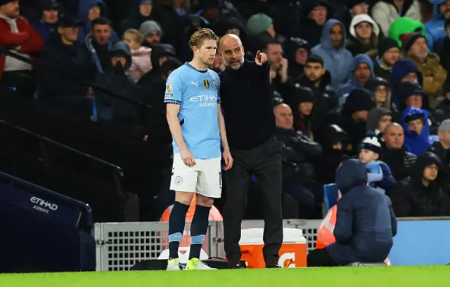 Pep Guardiola, Manager of Manchester City, gives instructions to Kevin De Bruyne