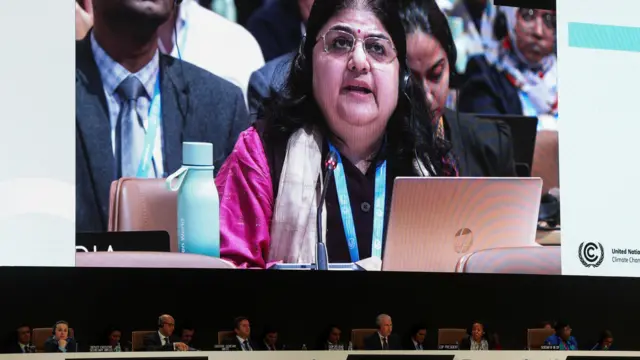 A screen displays Chandni Raina as she speaks during a closing plenary meeting at the COP29 United Nations Climate Change Conference, in Baku