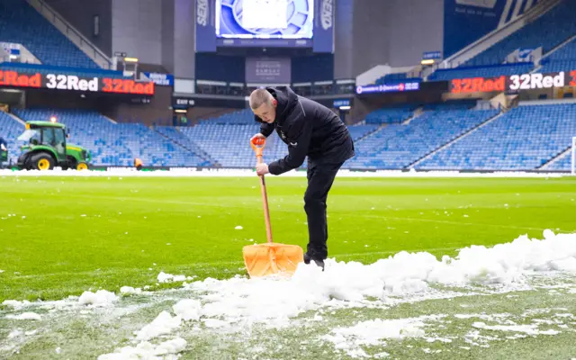 A general view of snow being cleared from the Ibrox pitch