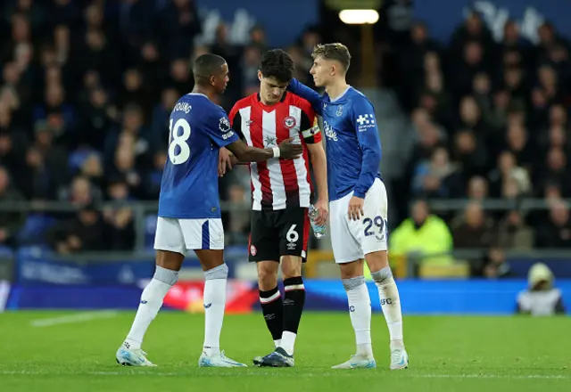 Christian Norgaard of Brentford is consoled by Ashley Young and Jesper Lindstrom